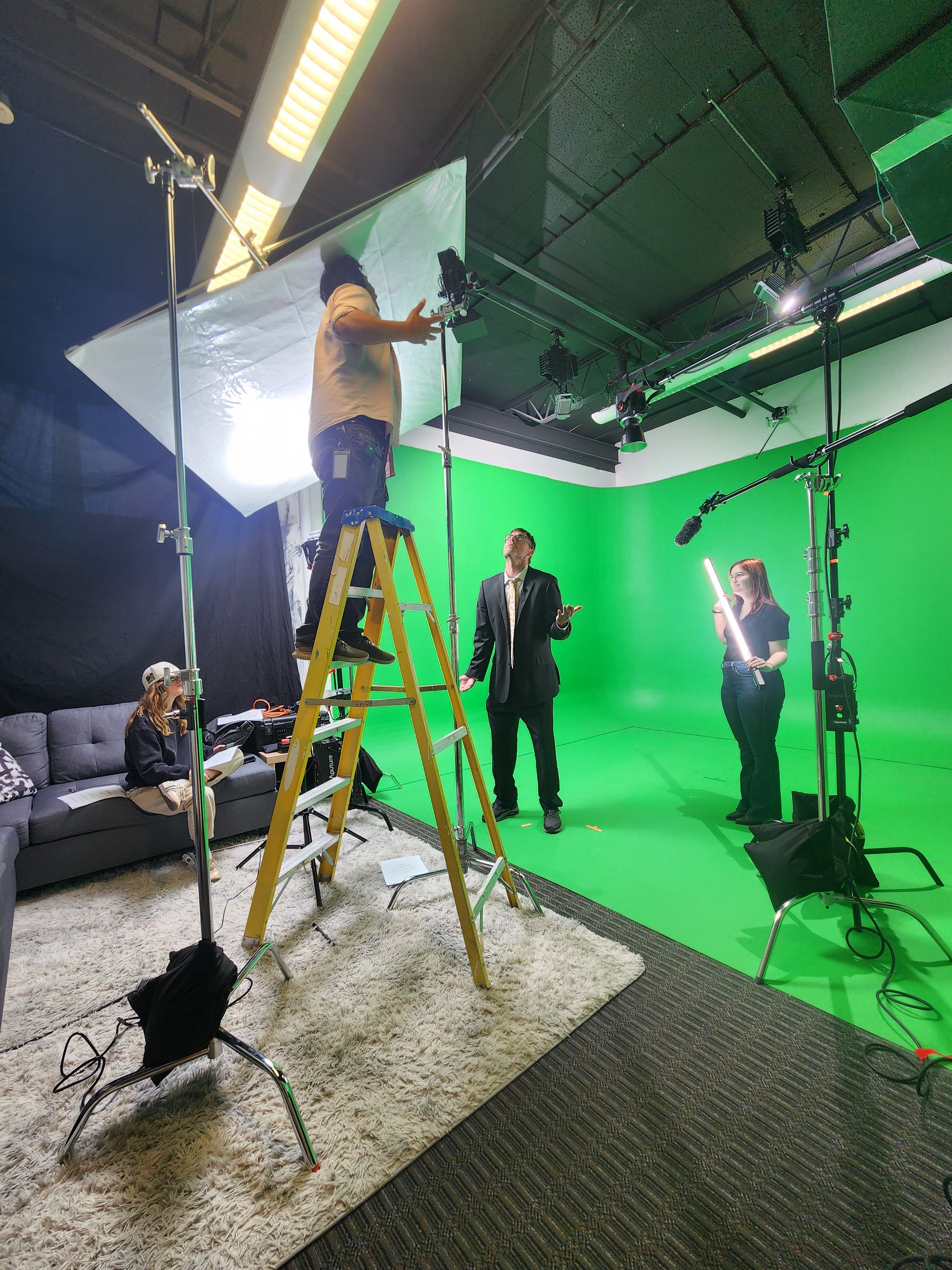 Pidoxa team setting up lighting on a green screen stage
